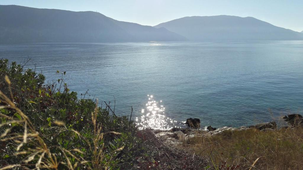 Hills and ocean view with sparkling sun on the water