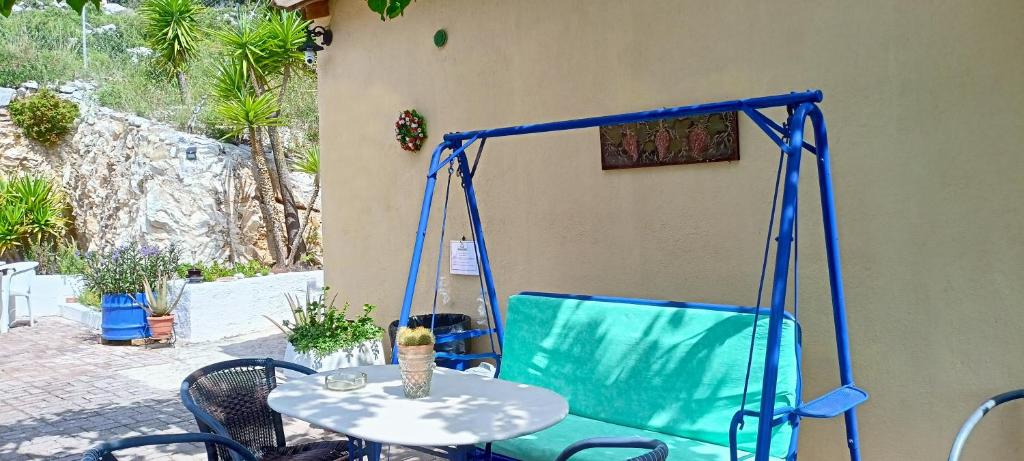 Close-up of the metal swing with turquoise cushions