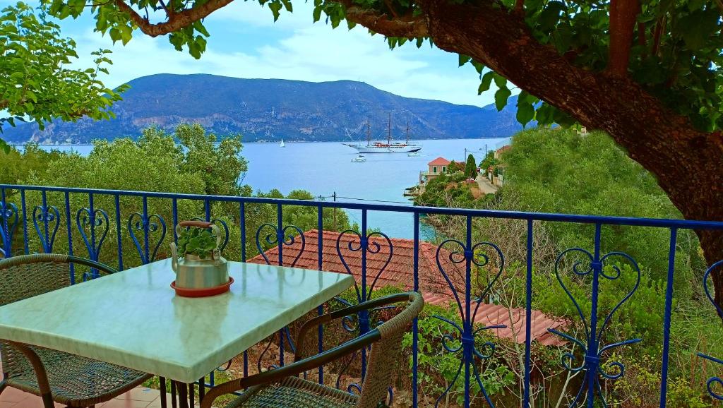 Veranda view overlooking the sea, mountains, and a large boat