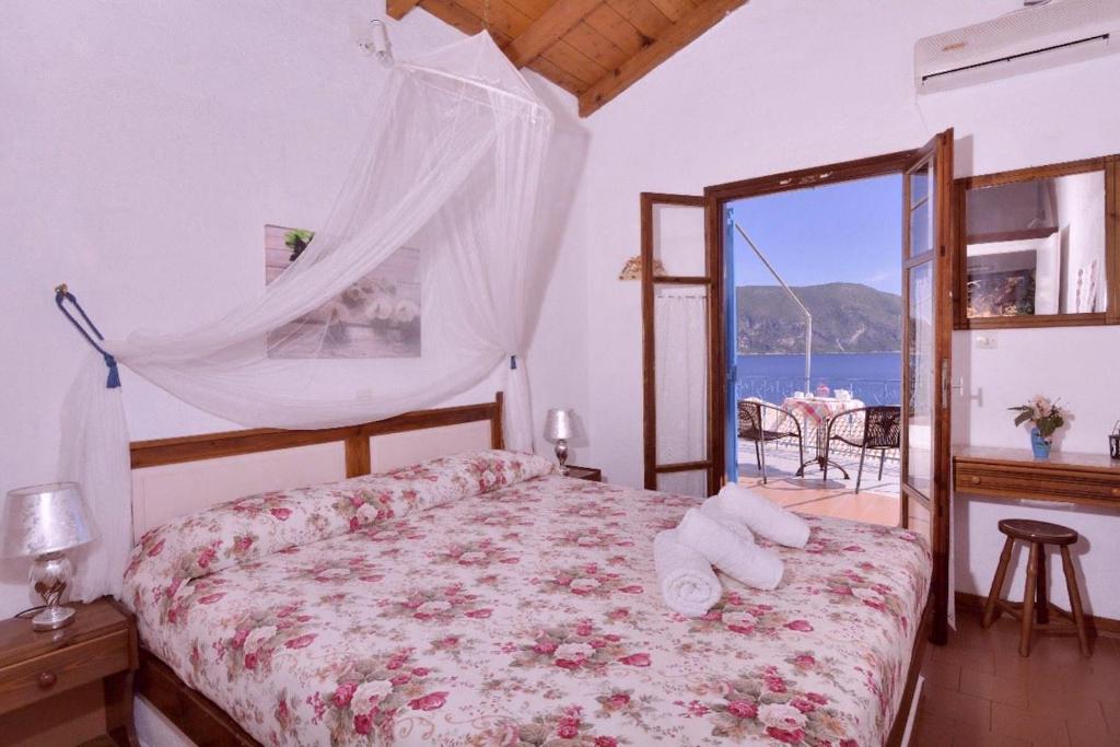 Bedroom interior with a queen-size bed and a view to the balcony